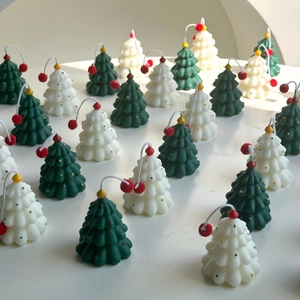 Macro shot of mini Christmas tree scented candles in white and dark green wax