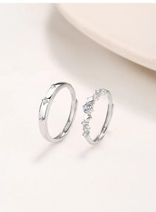 Detail showing S925 sterling silver couple rings with star patterns and zircon inlay