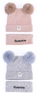 Detail of knitted baby winter hat set with double faux fur pom-poms and Moonlight label