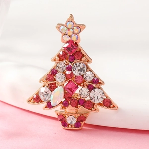 Macro detail of Christmas tree brooch with colorful rhinestones and gold star topper