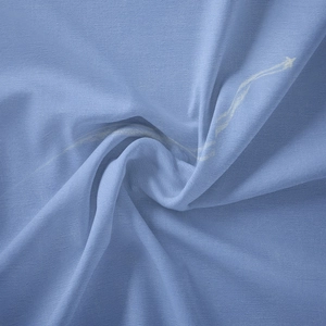 Detail of soft misty blue bohemian tapestry fabric with white meteor star print