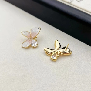 Close-up of S925 silver butterfly earrings with pink crystal and golden metallic base