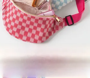 Detail of red checkered waist bag showing golden zipper and spacious inner storage