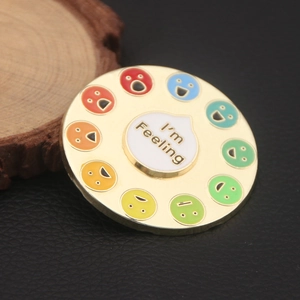 Close-up of circular enamel pin with I'm Feeling dial and colorful mood emoji indicators