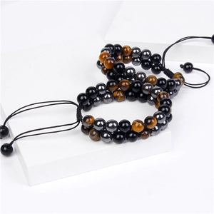 Detail view of double-layer tiger eye and obsidian beads on adjustable braided cord