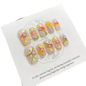 Handmade citrus-themed press-on nails with 3D lemon designs and sparkling gems