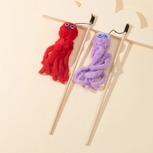Detailed view of red and purple plush octopus cat wands with natural wooden sticks