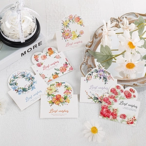 Detailed view of floral greeting cards with Best Wishes text and romantic flower illustrations
