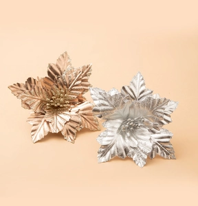 Close-up of artificial rose gold and silver glitter Christmas flowers with leaf textures