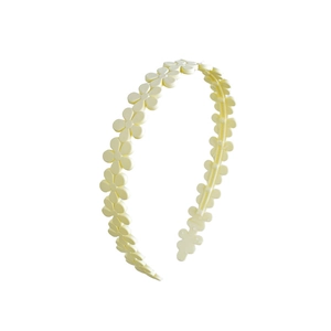 Detail view of yellow matte acrylic floral headband with continuous flower design