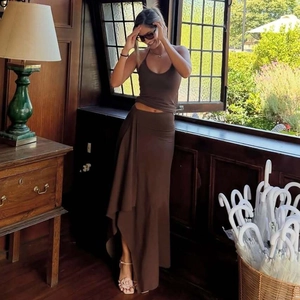 Detail of a brown two-piece summer set with halter top and irregular long skirt