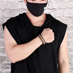 Men's punk style black braided leather bracelet with gold metal chain on male wrist