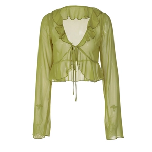 Detailed view of green sheer mesh blouse with ruffle trim and front tie closure