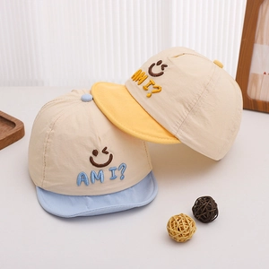 Detail of embroidered smile pattern on quick-dry cotton baby baseball hats in blue and yellow