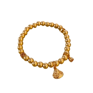 Golden bead bracelet with Buddha charm, lucky coin bead and bell on white background