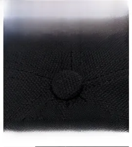 Close-up of the black twill fabric crown with top button and stitched seam details