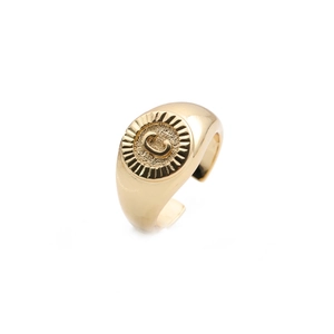 Close-up of gold plated adjustable ring with embossed letter C detail on surface