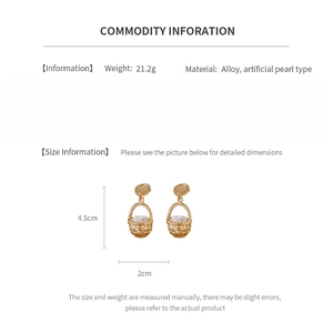 Detail view of gold vintage hollow basket earrings with faux pearl and size dimensions