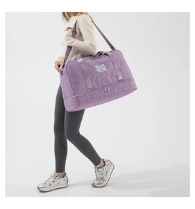 Detailed side view of purple quilted star pattern fitness bag with shoe compartment