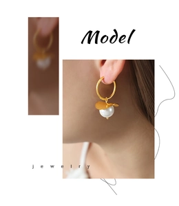 Close-up of elegant gold pearl drop earring worn by a model in a luxury style