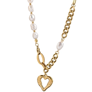 Minimalist pearl necklace with a textured golden heart pendant in asymmetric design