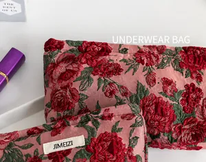 Dettaglio delle trousse in jacquard floreale rosa e rosso con tessuto morbido