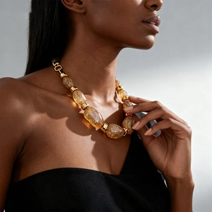 Detailed view of oversized golden glitter beads on a vintage acrylic sweater necklace