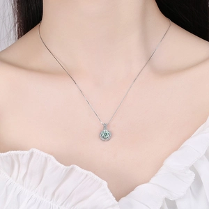 Elegant S925 silver necklace featuring a round green moissanite halo pendant on a female model
