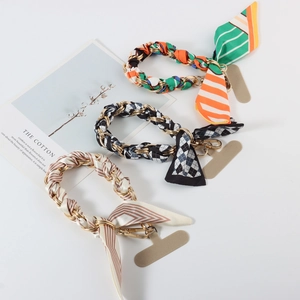 Three silk scarf wristlet straps with gold metal chains and phone tether tabs for handbags