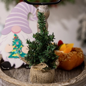 Close-up of 30cm mini Christmas tree with artificial pine needles and burlap base