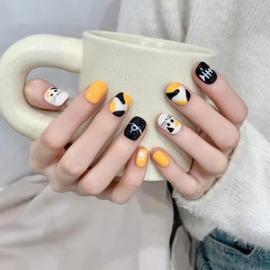 Handmade short round press-on nails featuring cute yellow cat and fishbone art design