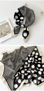 Detail of silk square scarf with classic black and white polka dot pattern and satin texture