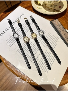 Detail view of oval leather strap watches with diamond-set bezels on vintage prose cards
