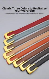 Detail view of colorful leather belts with golden U-shaped buckles and neat stitching