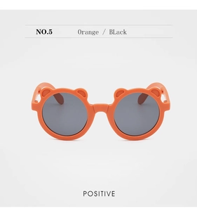 Front view of orange children's sunglasses with bear ears and dark lenses