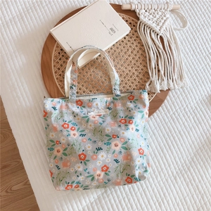 Vintage floral cotton tote bag with zipper and Animal patterns label on woven tray