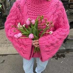 Rose pink chunky knit sweater featuring high neck and wide flared sleeves for winter