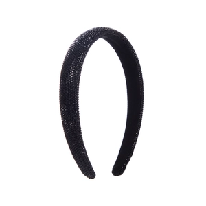 Close-up of handmade black headband with dense rhinestones and soft sponge padding