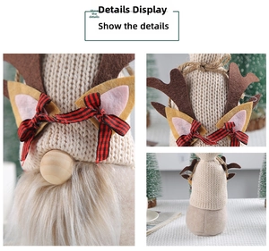 Detail of knit Christmas gnome with reindeer antlers and a red plaid bow on the hat