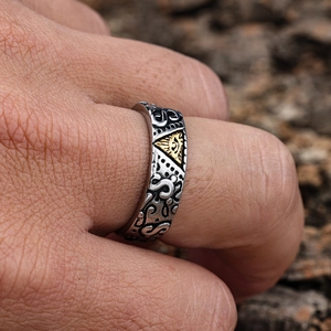 Vintage stainless steel Eye of Horus ring in silver and gold, worn on finger