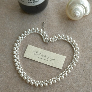 Elegant double-layered white pearl beaded necklace with silver clasp in heart shape