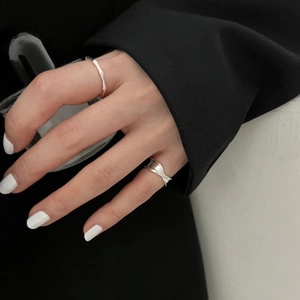 Detail of adjustable 925 sterling silver bamboo knot ring and overlapping wide band