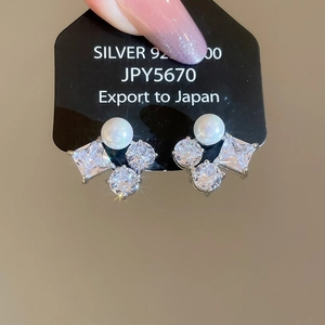 Detail showing 925 silver earrings with pearl and emerald-cut cubic zirconia insets