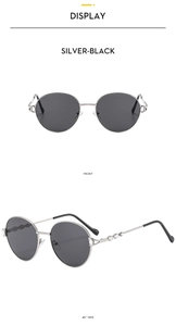 Front and 45-degree side views of silver-black metal round sunglasses with diamond accents