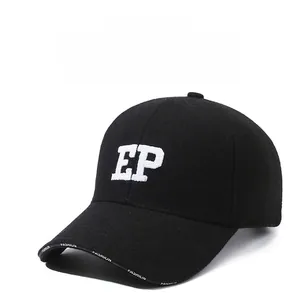 Close-up of white EP letter embroidery on black wool-like winter baseball cap fabric