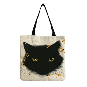 Close-up of artistic black cat print on beige canvas tote bag with sharp fabric texture