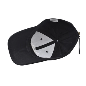 Detailed internal view of black cotton baseball cap showing reinforced seams and buckle