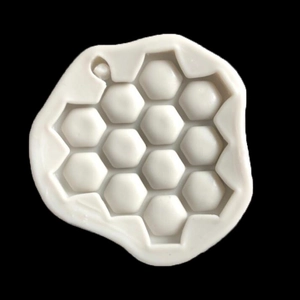 White silicone honeycomb cake mold with hexagonal cells and hanging hole for DIY baking