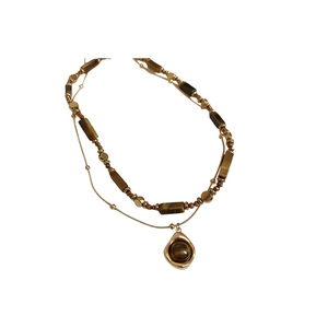 Vintage double-layer gold necklace with tiger eye beads and an irregular gold pendant