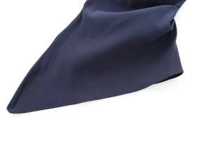 Close-up of dark blue fabric showing high-quality stitching and asymmetric hem details